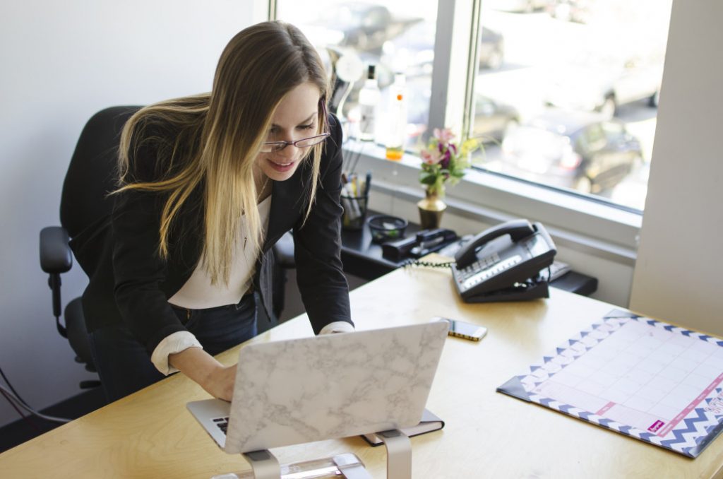 A business woman at her desk with a laptop