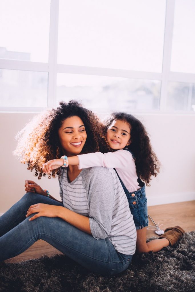 A young mother spending time with her daughter at home